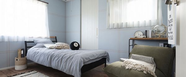 写真：淡いブルーの壁紙の寝室